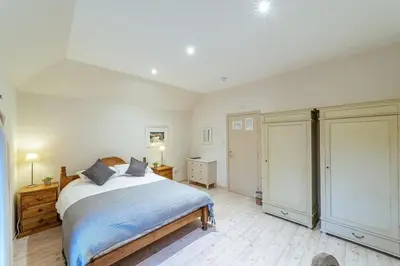 a bedroom with a large bed and two closets at Penninghame Estate - Bruce Apartment in Challoch