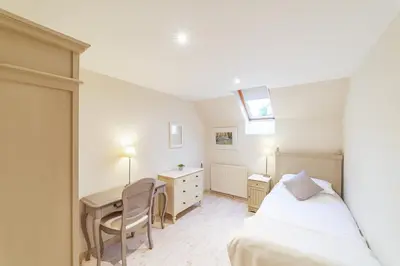 a bedroom with a bed and a desk and a desk at Penninghame Estate - Bruce Apartment in Challoch