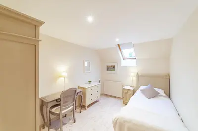 a bedroom with a bed and a desk and a table at Penninghame Estate - Bruce Apartment in Challoch