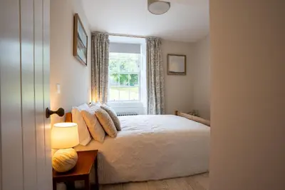 a bedroom with a bed and a window at Penninghame Estate - Earl's Library in Challoch