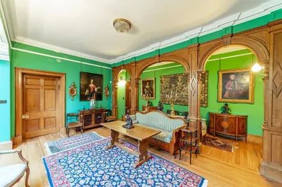a living room with green walls and a table at Penninghame Estate - Tower Apartment in Challoch