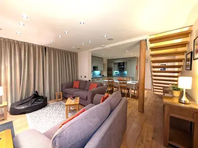 a living room with a couch and a table at The Coach House at Durhamhill with llamas & games room mini cinema in Kirkpatrick Durham