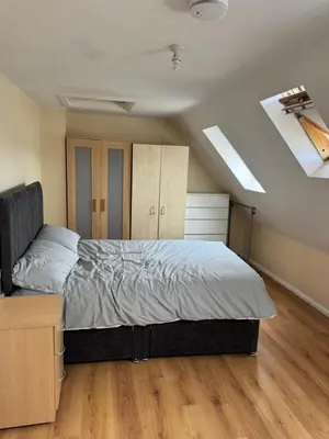 a bedroom with a bed and a skylight at Your Base To Explore London in Moffat