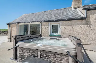 a hot tub in front of a house at 3 Bed in Leswalt oc-g32241 in Leswalt