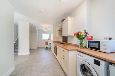 a kitchen with a washing machine and a microwave at 3 Bed in Leswalt oc-g32241 in Leswalt