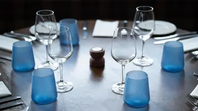 a table with wine glasses and blue decorations on it at The Briery in Workington