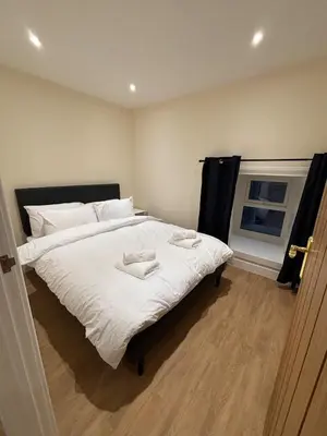 a bedroom with a large bed with two towels on it at Ballavelt in Isle of Man