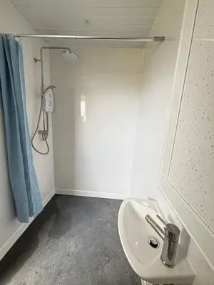 a bathroom with a sink and a shower at Ballavelt in Isle of Man