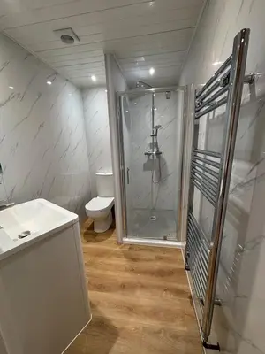 a bathroom with a shower and a toilet at Ballavelt in Isle of Man