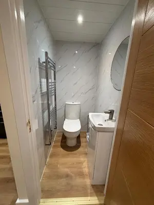 a small bathroom with a toilet and a sink at Ballavelt in Isle of Man