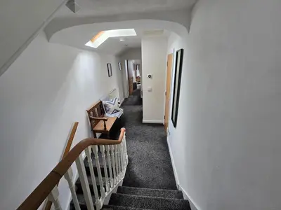 a hallway of a house with stairs and a room at Central Portrush Townhouse available for Open Golf in Moffat
