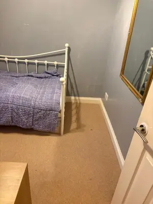 a bedroom with a bed and a mirror at Single Room in Moffat
