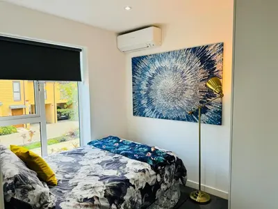 a bedroom with a bed and a painting on the wall at Middle Kent Lux! in Moffat