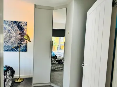 a hallway with a mirror and a lamp in a room at Middle Kent Lux! in Moffat