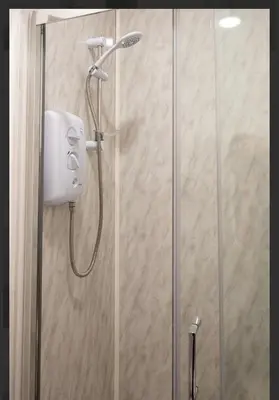 a shower with a shower head in a bathroom at Central Mews Free Wi-Fi-Parking-Contractors in Newton Stewart