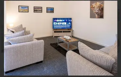 a living room with two couches and a television at Central Mews Free Wi-Fi-Parking-Contractors in Newton Stewart