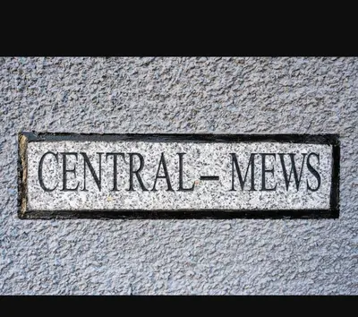 a sign that says central news on the side of a building at Central Mews Free Wi-Fi-Parking-Contractors in Newton Stewart