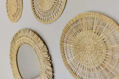 a group of straw plates on a white wall at Welcoming Home in Hurlford, Kilmarnock - Bonnie Lodgings in Hurlford