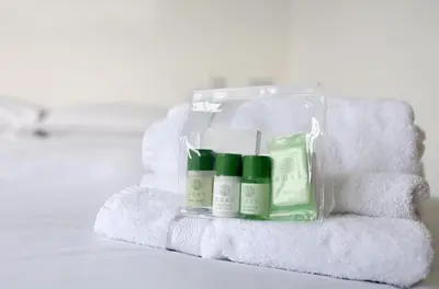 a package of soap and moisturizers on a pile of towels at Newly built luxury cabin in Moffat