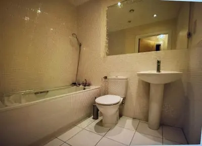 a bathroom with a sink and a toilet and a bath tub at Grebe House in Moffat