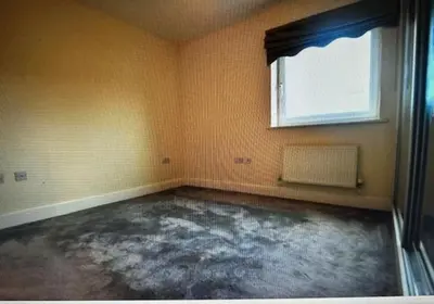 an empty room with a window and a concrete floor at Grebe House in Moffat