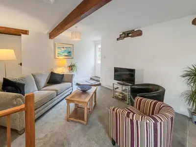 a living room with a couch and two chairs at Cottage At Brathen in Penrith