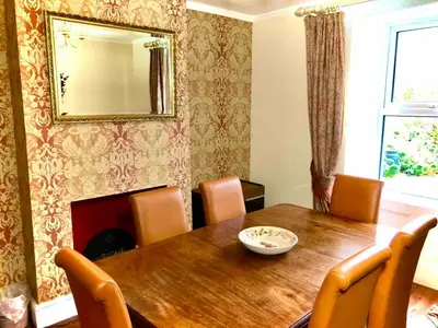 a dining room table with chairs and a mirror on the wall at The MireHouse - Georgian rural retreat in Ullock