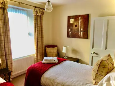 a bedroom with a bed and a window at The MireHouse - Georgian rural retreat in Ullock