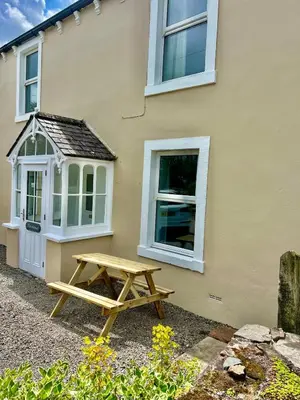 a picnic table in front of a house at The MireHouse - Georgian rural retreat in Ullock