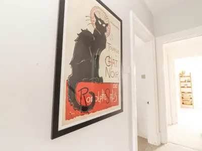 a picture of a black cat hanging on a wall at 43 Station Road in Keswick
