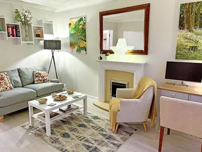 a living room with a couch and a fireplace at Rubby Banks Retreat in Cockermouth