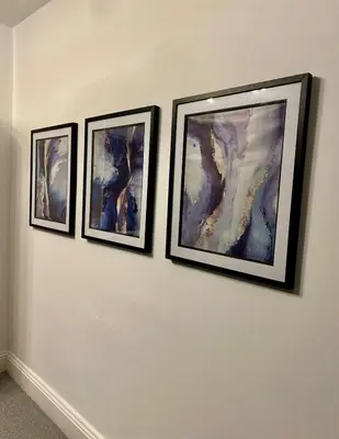 three framed paintings on a white wall at HULL 2BED Sleeps 4 BETTO Cosy Home! in Moffat