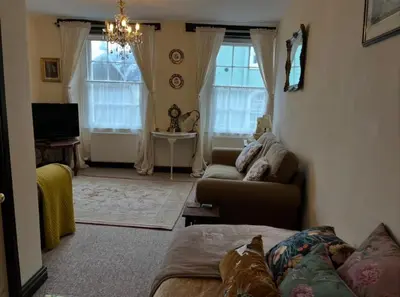 a living room with a couch and a tv at Sycamore Cottage - Lake District Hiking & Rivers in Cockermouth