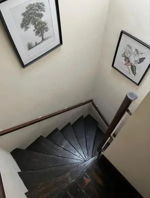 a stair case with an umbrella in a room at Sycamore Cottage - Lake District Hiking & Rivers in Cockermouth