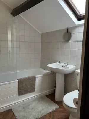 a bathroom with a sink and a tub and a toilet at Sycamore Cottage - Lake District Hiking & Rivers in Cockermouth