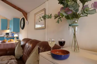 a living room with a couch and a table with wine glasses at The Biscuit Box Ideal For Couples Or Families in Low Hesket