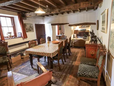 a dining room with a table and chairs at Chapel Cottage in Cleator