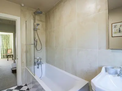 a bathroom with a tub and a sink at Claymoddie in Newton Stewart