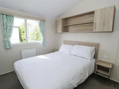 a bedroom with a large white bed and a window at Manor House Gold 2 Bedroom 20C in Maryport