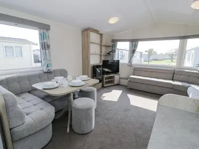 a living room with a couch and a table at Manor House Gold 2 Bedroom 20C in Maryport