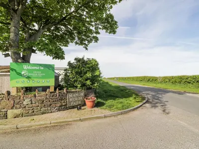 a sign on the side of a road at Manor House Platinum 3 Bedroom 16E in Maryport