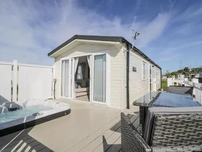 a small house with a hot tub on a deck at Manor House Platinum 3 Bedroom 16E in Maryport