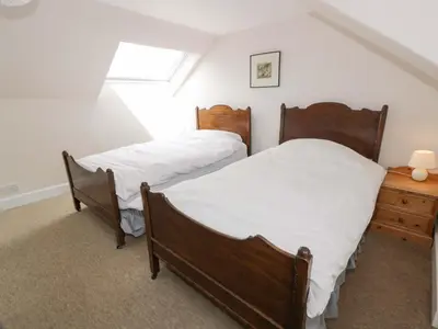 two twin beds in a room with a window at Townhead of Auchenbainzie in Thornhill