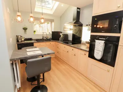 a kitchen with a counter and a stove top oven at 10 Keekle Terrace in Cleator Moor