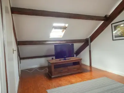 a tv sitting on a wooden stand in a room at Emilys View, Ireby budget accommodation with fell views in Ireby