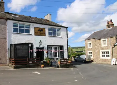 a building with a car parked in front of it at Emilys View, Ireby budget accommodation with fell views in Ireby
