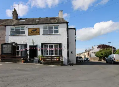 a white building with a sign in front of it at Emilys Apartment, Ireby with fell views, ideal budget holiday for a family in Ireby