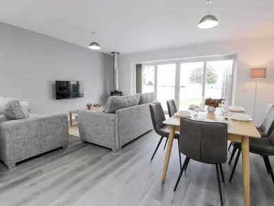 a living room with a table and chairs at Beach House in Stranraer