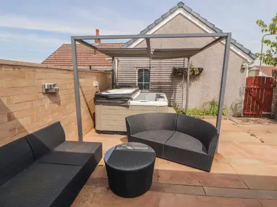 a patio with a grill and a couch and a barbecue at 3 Hawk Place in Whitehaven