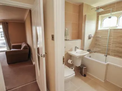 a bathroom with a sink and a toilet and a bath tub at 3 Hawk Place in Whitehaven